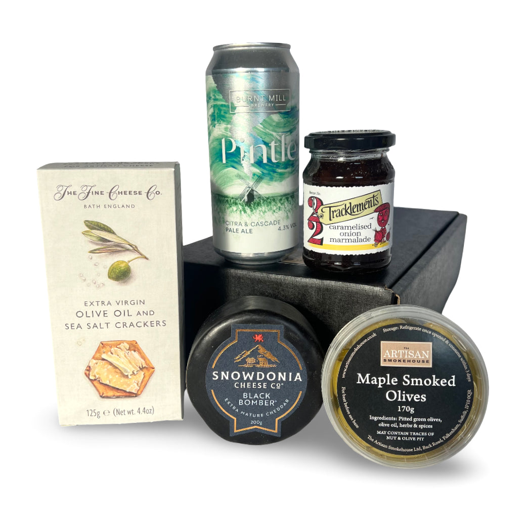 Cheese gift set with beer, crackers, cheese and olives, on a white background