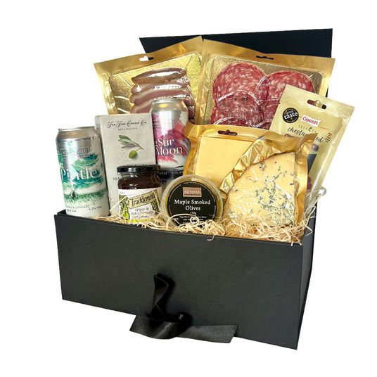 Gourmet Valentine's gift basket with meats, cheeses, and other snacks in a black box.