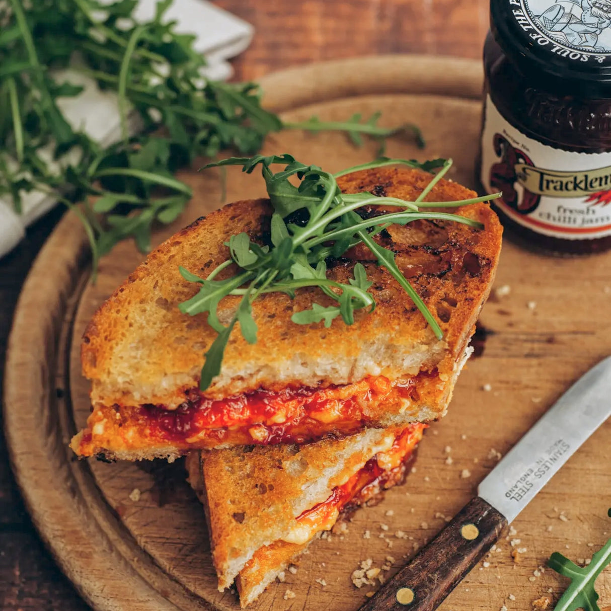 Grilled toasted cheese sandwich with Tracklements Fresh Chilli Jam on a wooden board