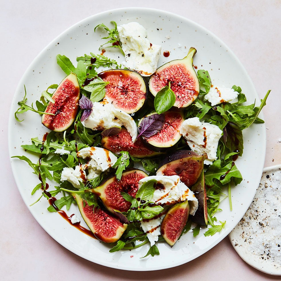 Salad with figs, leaves, and Mozzarella with balsamic glaze drizzle