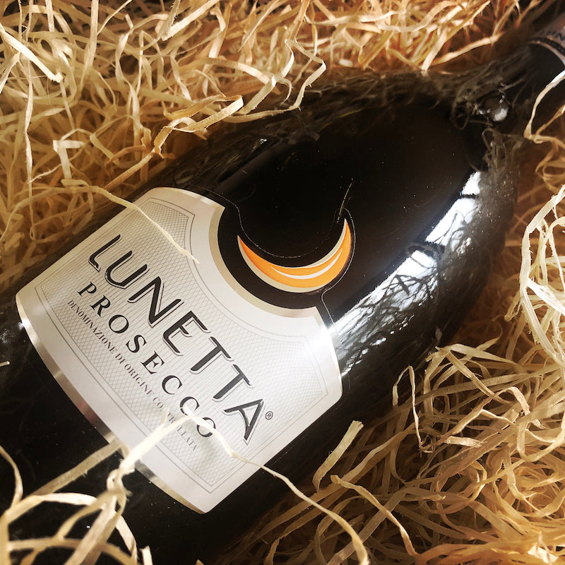 Lunetta Prosecco bottle on a bed of straw
