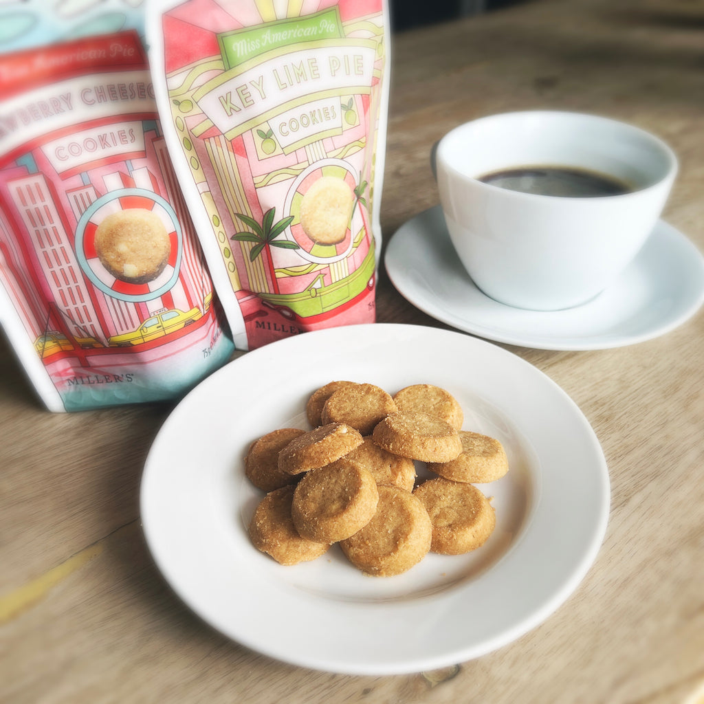 A plate of cookies next to a cup of coffee