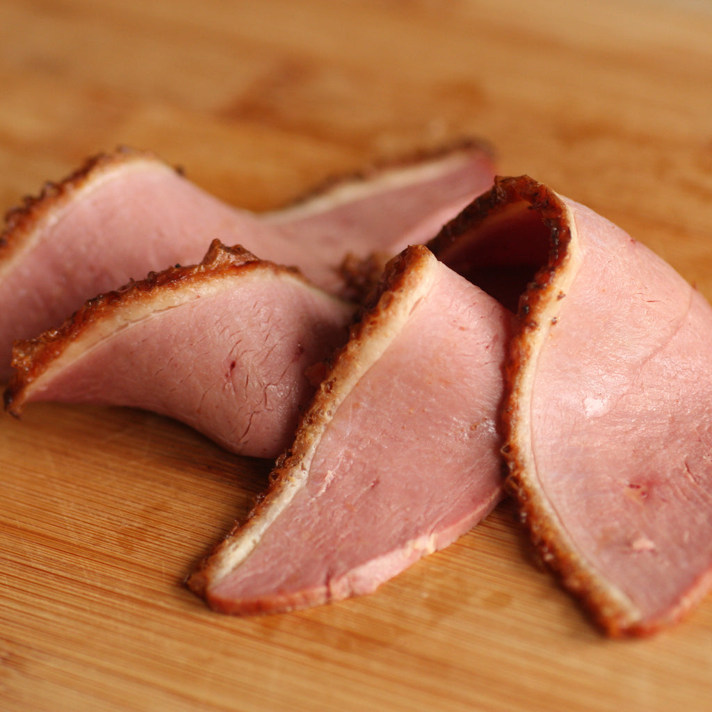 Slices of The Artisan Smokehouse's smoked duck breast on board