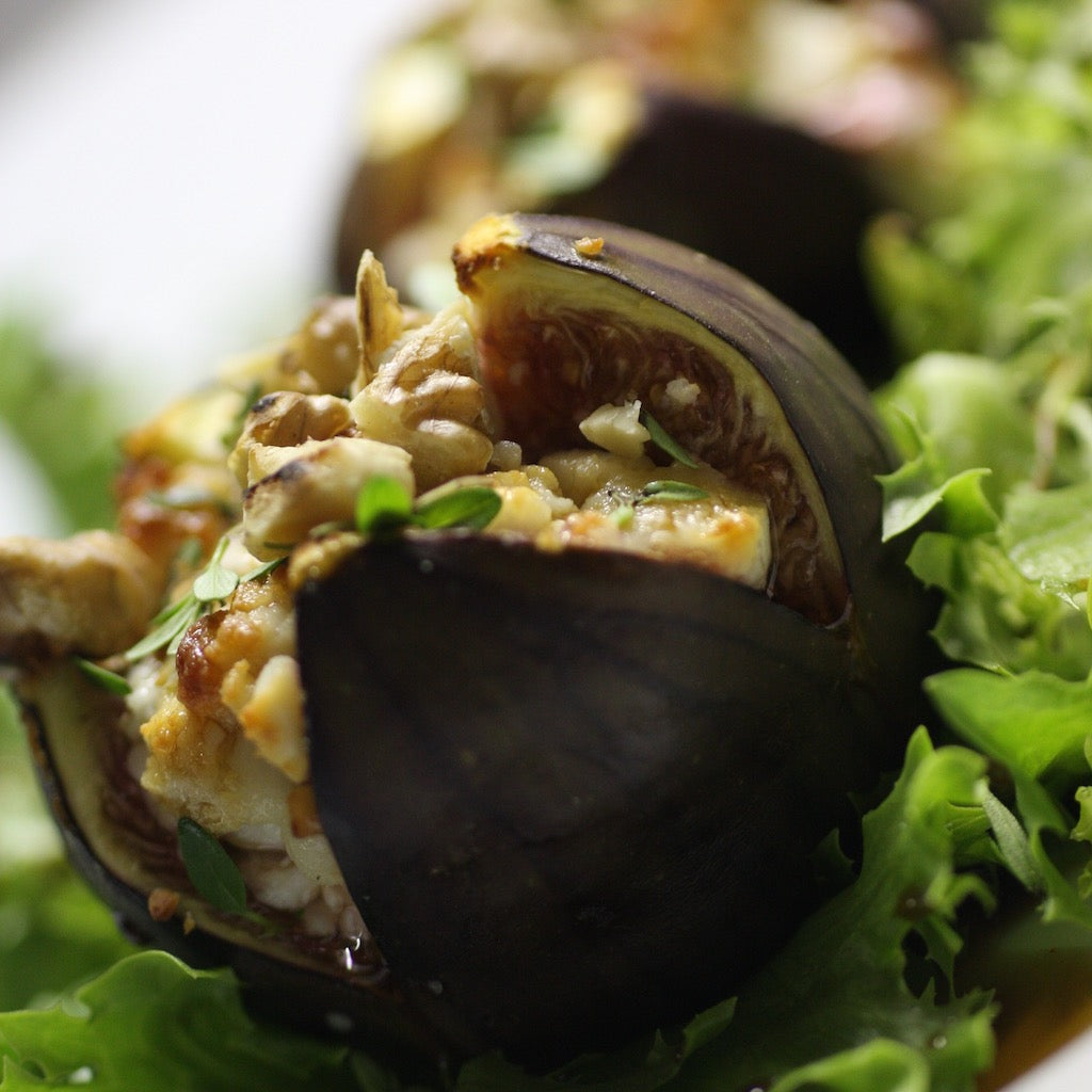 A fresh fig stuffed with smoked Stilton & walnuts on lettuce leaves