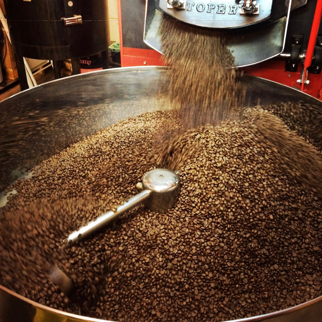 Whole coffee beans in a coffee roaster
