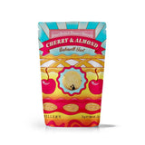 A colorful stand-up pouch filled with Millers Cherry & Almond Bakewell Tart cookies on a white background. 