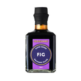 A bottle of Seggiano Fig Balsamic Glaze with a black cap and a purple label, shown on a plain white background.