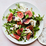 Salad with figs, leaves, and Mozzarella with balsamic glaze drizzle