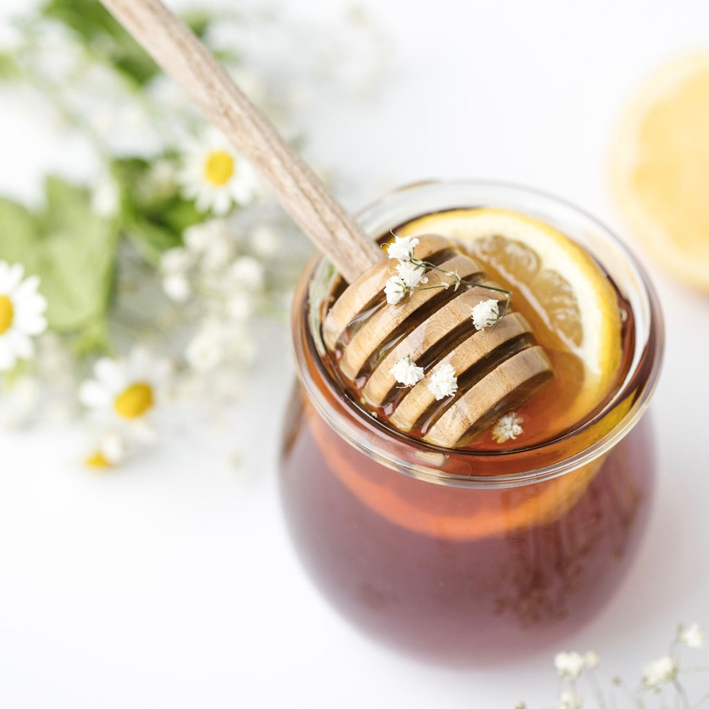 A jar of Suffolk honey with honey dipper
