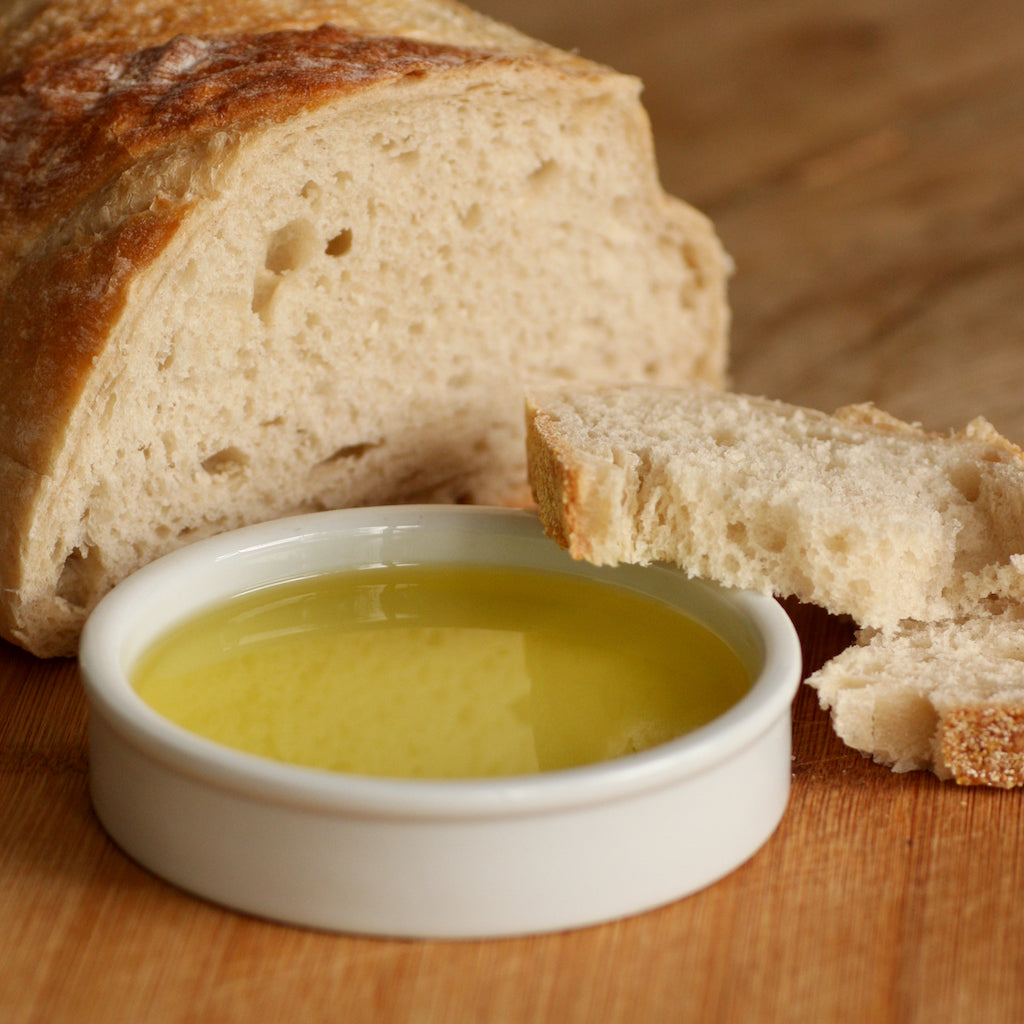 A ramekin of The Artisan Smokehouse's smoked Italian olive oil with dipping bread 