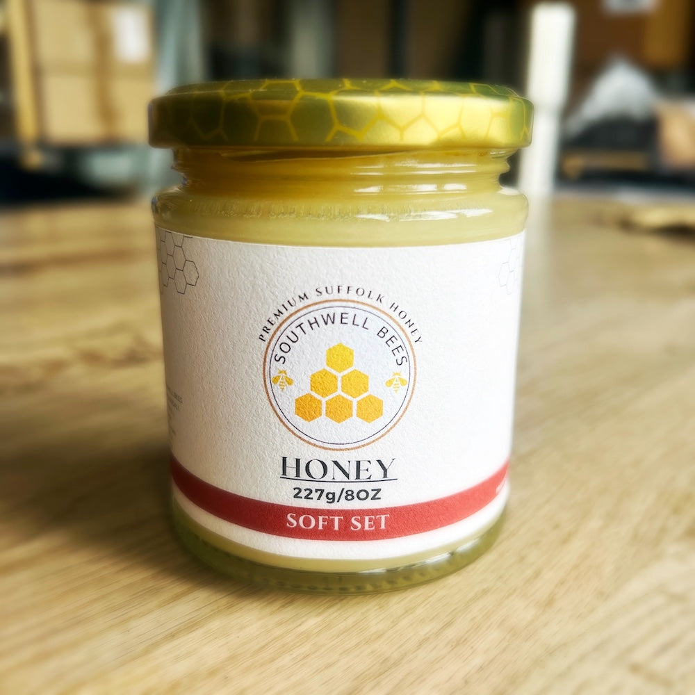 Jar of Southwell Bees honey on a wooden surface