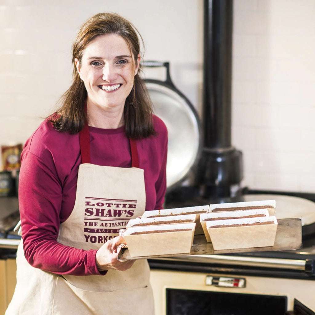 Lottie Shaw in kitchen with tray of baked cakes