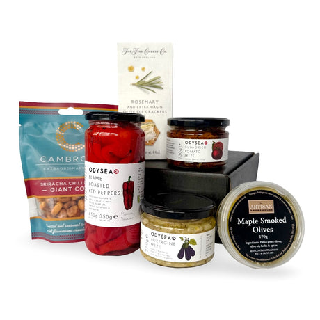 The Meze gift set with assorted food items including jars of meze, peppers, crackers a and giant corn