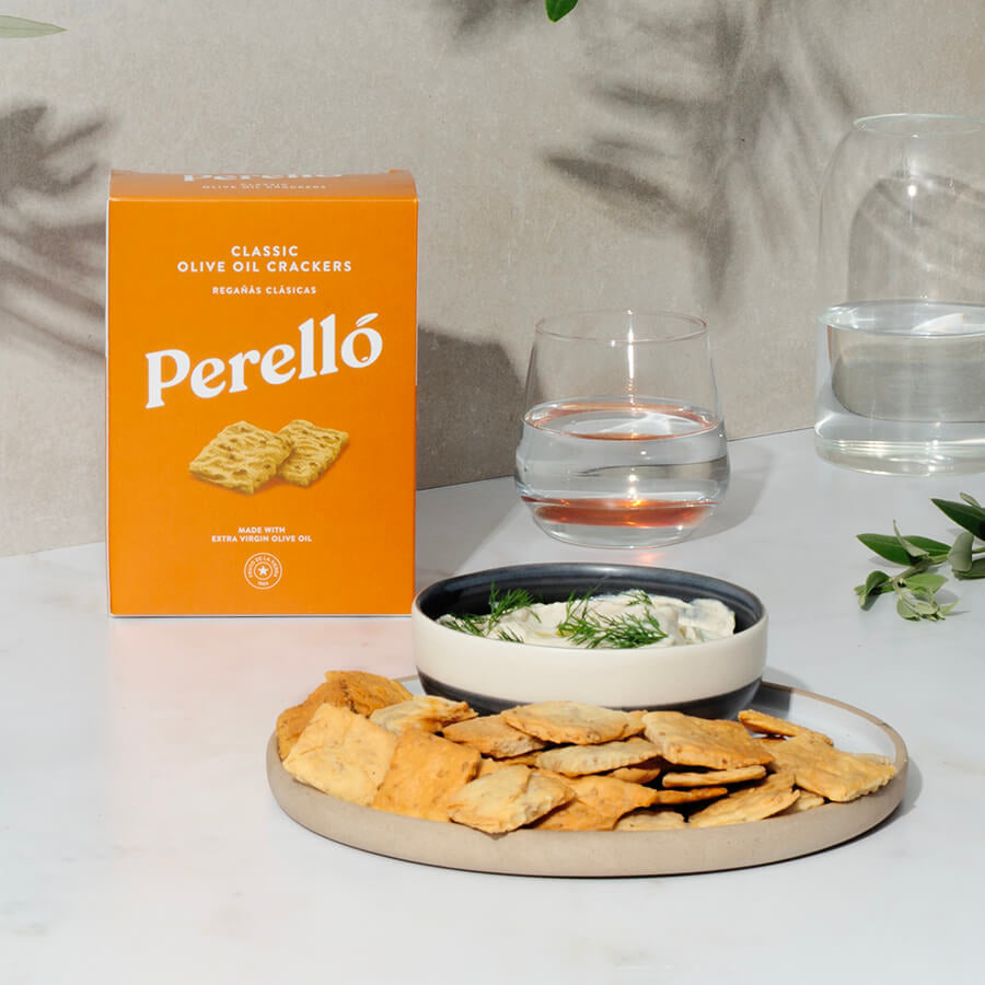 Perello crackers on a plate with a bowl of dip