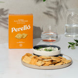 Perello crackers on a plate with a bowl of dip