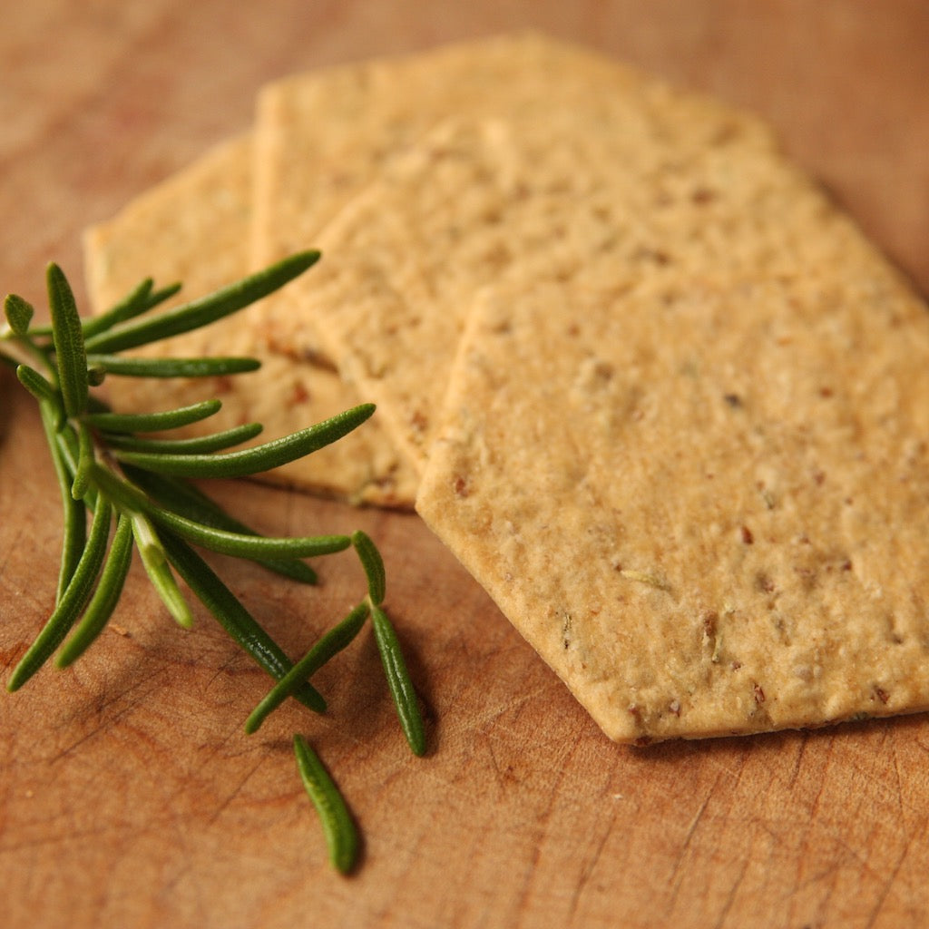 Several rosemary crackers on cheese board