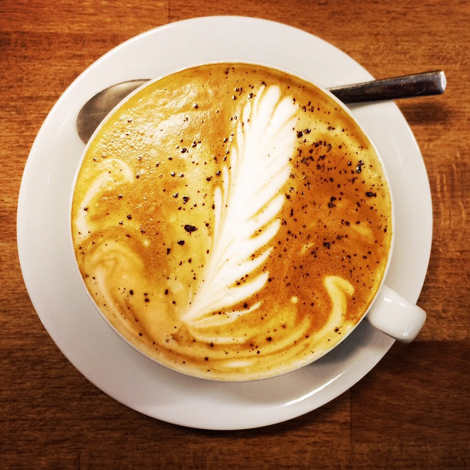 A cup of Coffeelink coffee on saucer with spoon