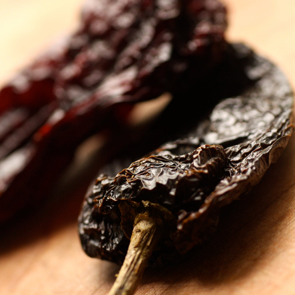 The Artisan Smokehouse's smoked whole ancho chillies on chopping board