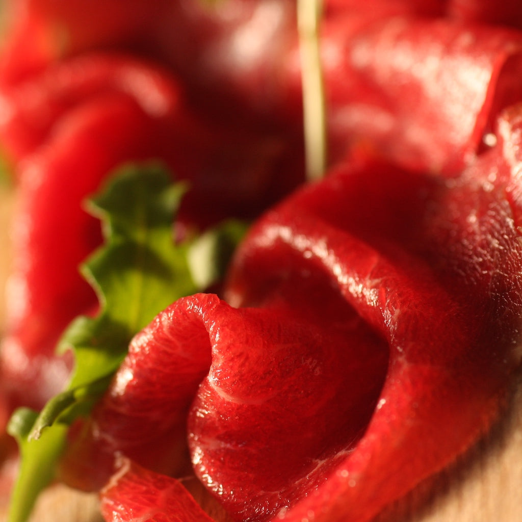 Slices of The Artisan Smokehouse's smoked British beef fillet with rocket