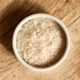 A white ramekin filled with smoked sea salt flakes