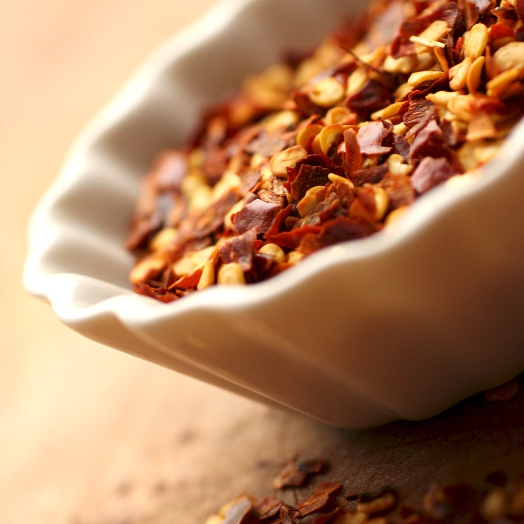 A pot filled with The Artisan Smokehouse's smoked dried chilli flakes