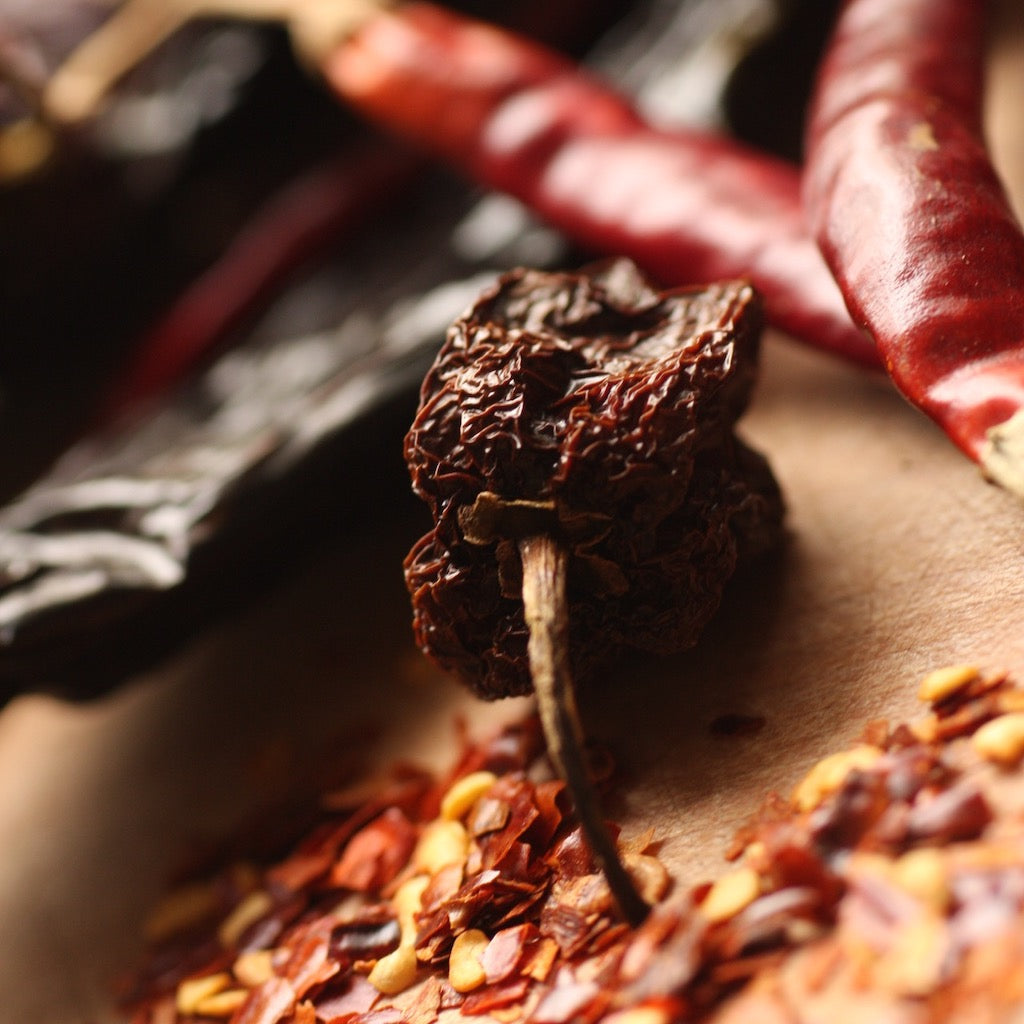 Smoked & dried chillies on chopping board