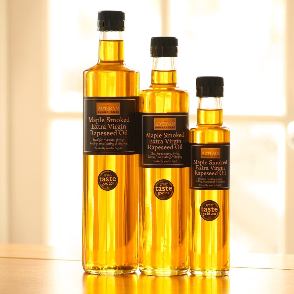 Three different size bottles of maple smoked rapeseed oil