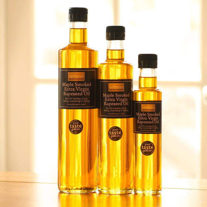 Three bottles of Artisan Smokehouse Maple Smoked Extra Virgin Rapeseed Oil on a shelf