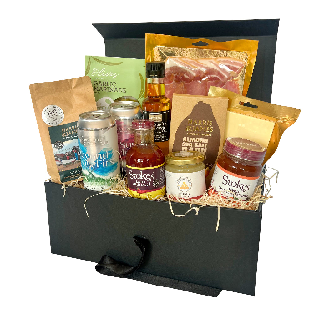 The Suffolk Hamper with various food items including drinks and snacks in a black hamper box.