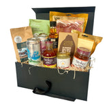 The Suffolk Hamper with various food items including drinks and snacks in a black hamper box.