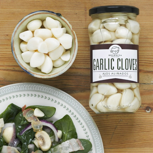 Pickled garlic gloves served with salad
