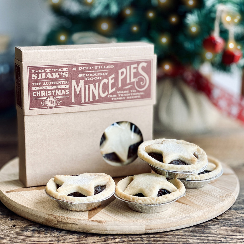 Traditional mince pies in front of Christmas tree